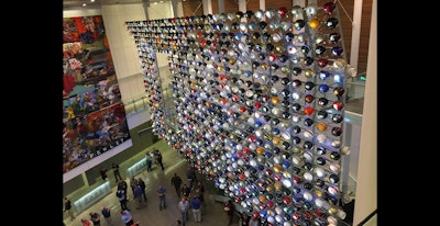 The College Football Hall of Fame in Atlanta includes a 3-story display of more than 765 college football team helmets. (ID photo)