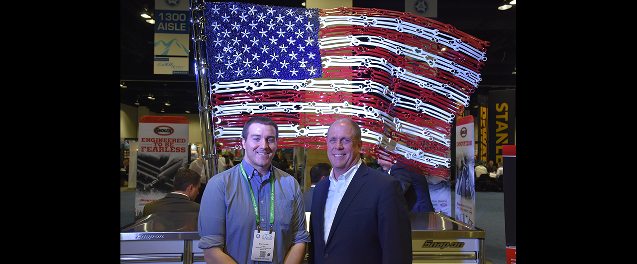 Snap-on Industrial Vice President Michael Carr with ID Editor Mike Hockett in front of an American flag made out of Snap-on tools at the ISA Convention in Denver on April 24.