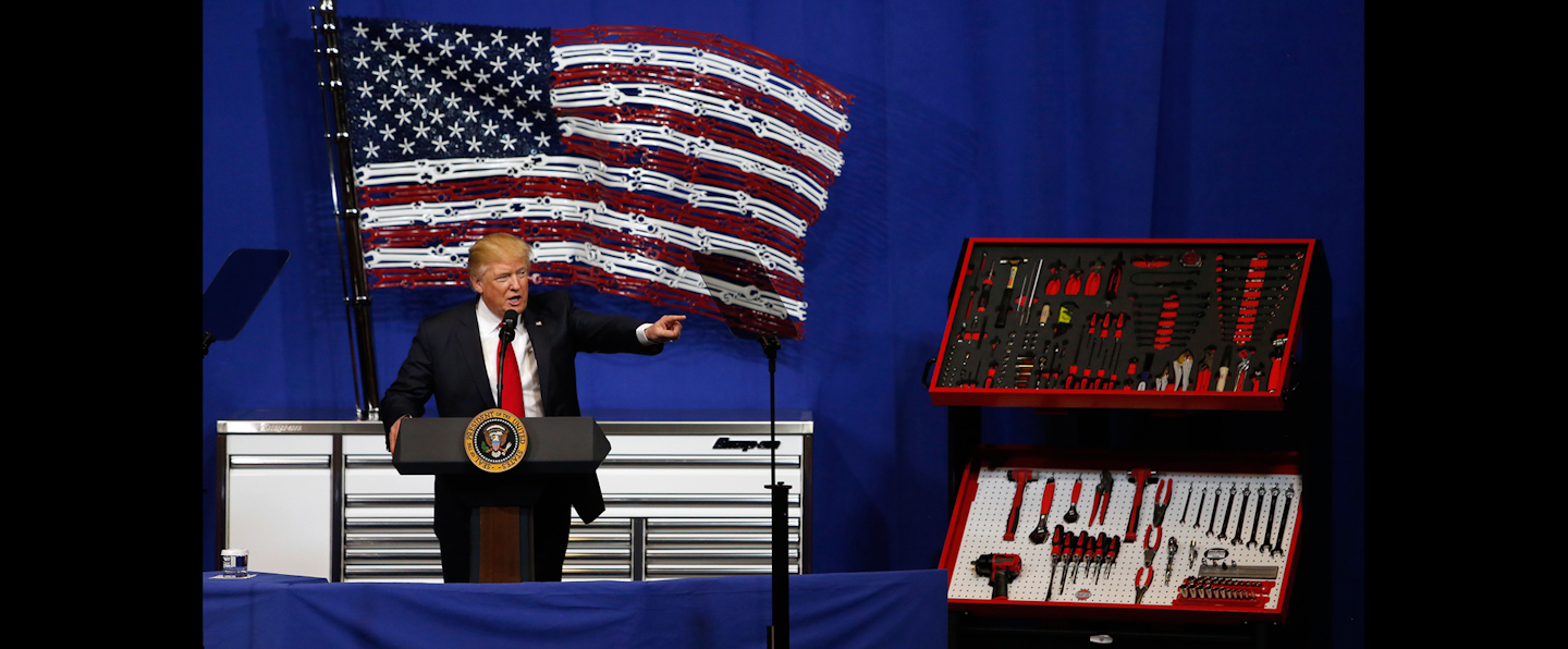 President Donald Trump speaks in front of an American flag made out of Snap-On Tools on April 18 in Kenosha, Wis. (AP Photo/Kiichiro Sato)