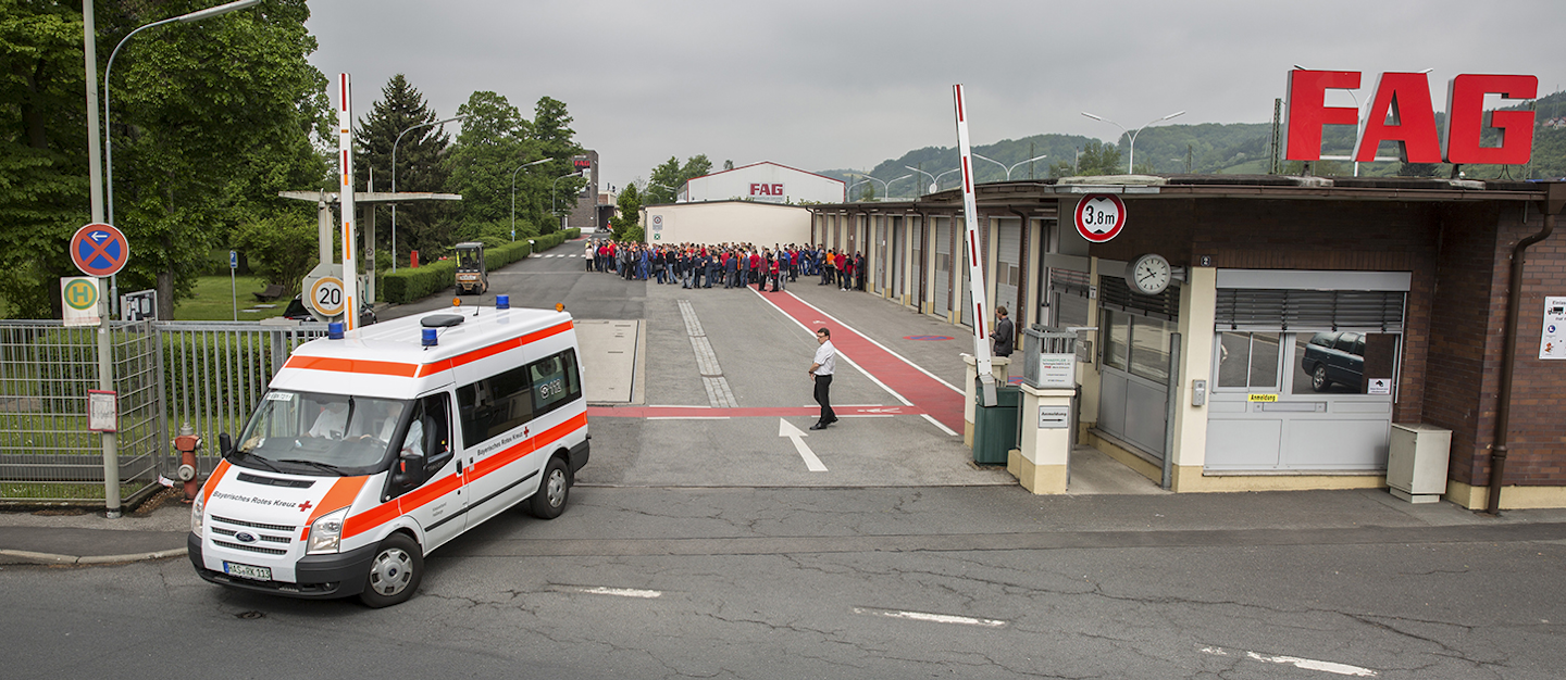 An ambulance leaves FAG Schaeffler company in Eltmann, Germany, Monday, May 15, 2017. German police say 13 people have been injured in an explosion in the factory in Bavaria. Police said the four of those injured in the Monday morning explosion suffered f