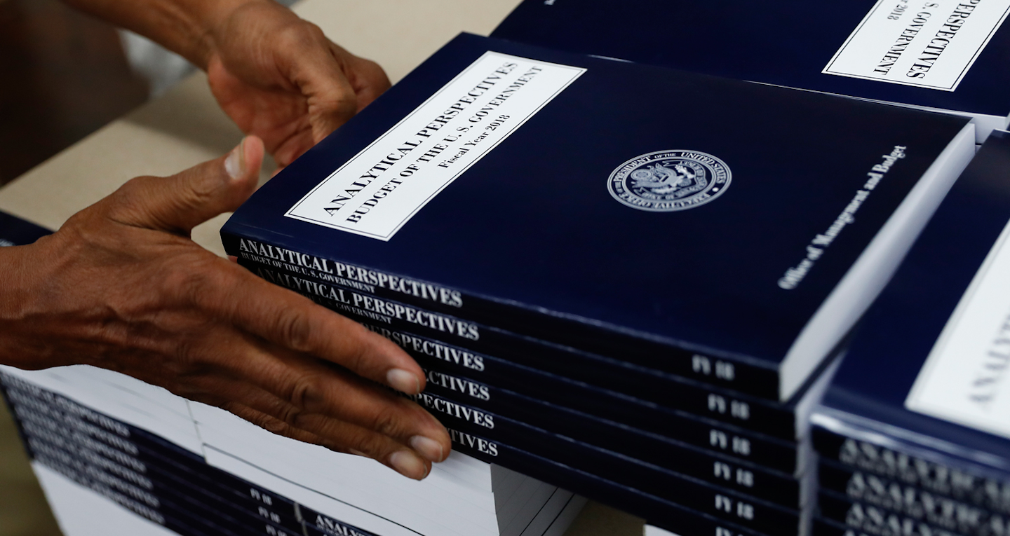 In this photo taken May 19, 2017, a GPO worker stacks copies of 'Analytical Perspectives Budget of the U.S. Government Fiscal Year 2018' onto a pallet at the U.S. Government Publishing Office's (GPO) plant in Washington. (AP Photo/Carolyn Kaster)