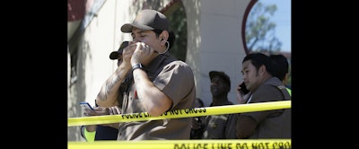 UPS workers gather outside a UPS package delivery warehouse where a shooting took place Wednesday in San Francisco. A UPS spokesman says four people were injured in the shooting at the facility and that the shooter was an employee. (AP Photo)