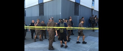 UPS workers gather outside after a reported shooting at a UPS warehouse and customer service center in San Francisco on Wednesday. (AP Photo/Eric Risberg)