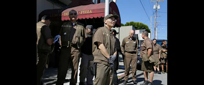 UPS workers gather outside a UPS package delivery warehouse where a shooting took place Wednesday in San Francisco. (AP Photo/Eric Risberg)