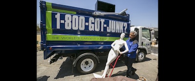 In this June 9 photo, 1-800-GOT-JUNK? business owner James Williams gets ready to load a store mannequin into a truck at the business, in Burbank, Calif. Removing the contents of a store is just one part of the job, says Williams. (AP photo)