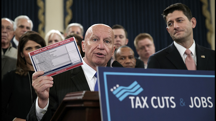 House Ways and Means Committee Chairman Kevin Brady, joined by Speaker of the House Paul Ryan, R-Wis., right, holds a proposed 'postcard tax filing form' as they unveil the GOP's far-reaching tax overhaul on Capitol Hill in Washington Thursday (AP photo).