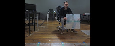 Scanalytics co-founder and CEO Joe Scanlin holds a smart floor sensor his company creates that track people's movements in Milwaukee. The sensors are among the tools retailers are using to gain insights on consumer habits. (AP photo)