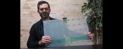 Scanalytics co-founder and CEO Joe Scanlin holds a smart floor sensor his company creates that track people's movements in Milwaukee. The sensors are among the tools retailers are using to gain insights on consumer habits. (AP photo)