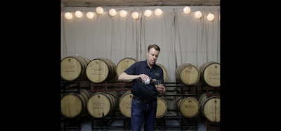 Steve Strong pours a glass of bourbon whiskey at his S.D. Strong Distilling business in Parkville, Mo. (AP Photo)