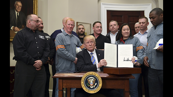 President Donald Trump holds up a proclamation on steel imports during an event in the Roosevelt at the White House in Washington Thursday, March 8. He also signed one for aluminum imports. (AP Photo)