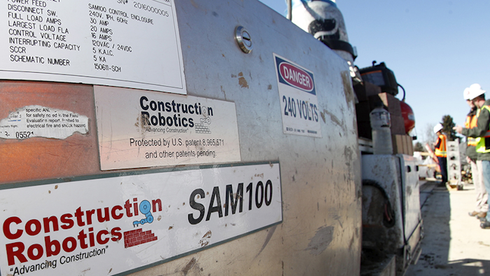 SAM, a semi-automated mason, works on the facade of a school in the south Denver suburb of Englewood, CO on Feb. 27. (AP)