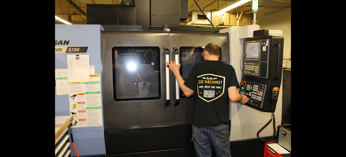 A Cline Tool CNC machinist watches the progress of a cutting tool being made.