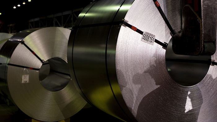 Shadows of workers are cast on rolls of coated steel at Stelco in Hamilton, Ontario in this June 29 photo. (AP)