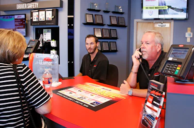 Greg Goodman, right, assists a customer on the phone while son Chandler Goodman, center, helps a customer at the counter, in their Alta Mere franchise in Oklahoma City. (AP)