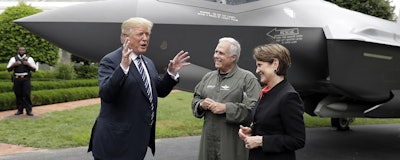 President Donald Trump talks with Lockheed Martin president and CEO Marilyn Hewson and director and chief test pilot Alan Norman in front of a F-35 as he participates in a 'Made in America Product Showcase' at the White House Monday. (AP)