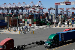 trucks travel along a loading dock at the Port of Long Beach in Long Beach, CA on Aug. 22. (AP)