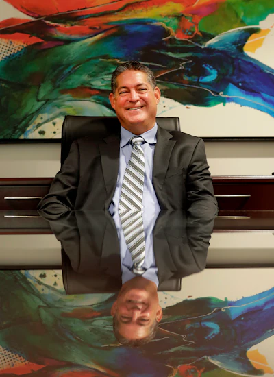 In this Oct. 4 photo, attorney Christopher Hildebrand poses for a photo his office in Scottsdale, AZ. Hildebrand was divorced and had to expand his practice from himself to a seven-lawyer firm to pay his spouse her settlement, alimony and child support. He calls the decade after his divorce the longest 10 years of his life because of the amount of work he had to do.