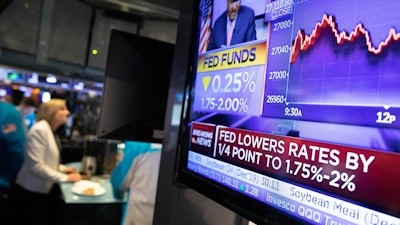 In this Sept. 18, 2019 file photo, a television monitor at the New York Stock Exchange carries the news after the Federal Reserve made its interest rate announcement.