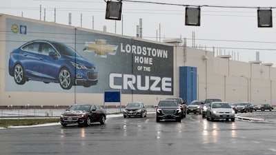 In this Nov. 27, 2018 file photo, a banner depicting the Chevrolet Cruze model vehicle is displayed at the General Motors' Lordstown plant in Lordstown, OH.