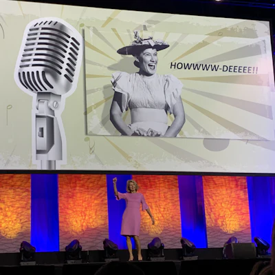 STAFDA CEO Georgia Foley beginning her Association Update speech on Nov. 11 by imitating Minnie Pearl with a 'Howdie' greeting.