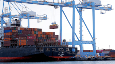 In this Nov. 4, 2019 photo, cargo cranes are used to take containers off of a Yang Ming Marine Transport Corporation boat at the Port of Tacoma in Tacoma, WA.