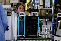 In this Nov. 20, 2019 file photo, workers with Apple products being assembled before President Donald Trump tours an Apple manufacturing plant in Austin, TX.