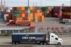 In this Oct. 2, 2019 file photo, trucks hauling shipping containers drive near containers stacked five-high at a terminal on Harbor Island in Seattle. US and China are trying to finalize a modest trade agreement to deescalate a trade war that has rattled financial markets and hobbled global economic growth.