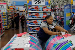 In this Nov. 27 file photo, Balo Balogun labels items in preparation for a holiday sale at a Walmart Supercenter in Las Vegas.