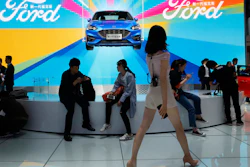 In this April 25, 2018 file photo, attendees visit the Ford booth during Auto China 2018 show held in Beijing, China.