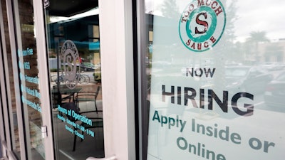 In this Nov. 4, 2019 file photo, a job posting is displayed near the entrance outside a restaurant in Orlando, FL.