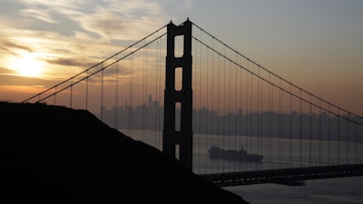 In this Oct. 28, 2019 file photo a Matson container ship passes the Golden Gate Bridge in Sausalito, CA.