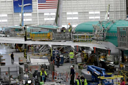 This March 27, 2019 file photo shows people working on the Boeing 737 MAX 8 assembly line during a brief media tour in Boeing's 737 assembly facility in Renton, WA.