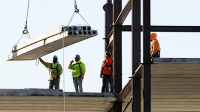 In this Dec. 3, 2019 file photo, workers erect a building under construction, in Philadelphia.