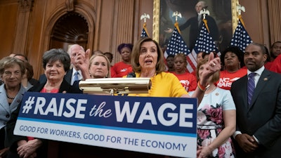 In this July 18, 2019 file photo, speaker of the House Nancy Pelosi joins fellow Democrats and activists seeking better pay as the House approved legislation to raise the federal minimum wage for the first time in a decade — to $15 an hour, at the Capitol in Washington.