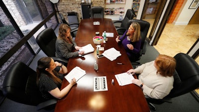 Jo Trizila, top right, President and CEO of Trizcom Public Relations, conducts a meeting with her staff Ann Littmann, right, Noel Hampton, bottom left, and Hayley Swinton at their office in Dallas on Tuesday, Jan. 21. The recent flu outbreak can really impact small businesses with small staffs and hurt a company's productivity. Some owners, like Trizila, are trying to mitigate the damage so the flu will not become a nightmare when they're trying to get clients' work done.