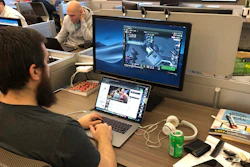 In this undated image provided by Cameron MacMillan, Jordan Davis, foreground, and Jason Wilson and Chad Wright, background work at the Better Collective Tennessee, RotoGrinders.com office in downtown Nashville. Sports can be a distraction at work the first few months of the year as pro football and college basketball hold their premier events. Business owners have to make a choice, whether, like McMillan at RotoGrinders.com, they'll allow or encourage staffers to enjoy the moment, or demand that everyone focus on work.
