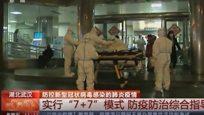 In this Thursday, Jan. 23 image from China's CCTV video, a patient is carried on a stretcher to an ambulance by medical workers in protective suits in Wuhan, China. China is swiftly building a hospital dedicated to treating patients infected with a new virus that sickened hundreds and prompted unprecedented lockdowns of cities home to millions of people during the country's most important holiday.