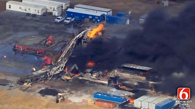 In this Jan. 22, 2018, file photo from video by Tulsa's KOTV/NewsOn6.com, fires burn at an eastern Oklahoma drilling rig near Quinton, OK. A Pittsburg County, OK jury has found National Oilwell Varco, a Houston-based company partially responsible for the 2018 explosion and fire that killed five men. The jury ordered the company to pay $1 million each to the estates of two of the victims.