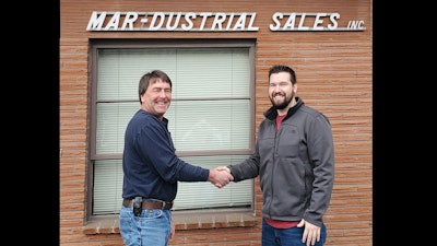 Drew Hansen (left), general manager of Mar-Dustrial Sales, and Joshua Hopkins, president of In Stock Parts, seal the deal.