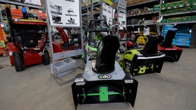 In this Jan. 27, 2020 photo, snow blowers are lined up at a Home Depot store location in Boston.