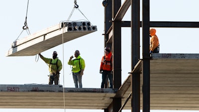 In this Dec. 3, 2019 file photo, workers erect a building under construction in Philadelphia. Spending on US construction projects edged down a slight 0.2% in December 2019, closing out a year when total construction registered its first annual decline in eight years.