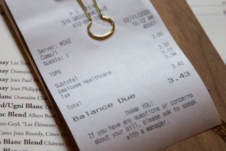 In this Feb. 11 photo, a line item shows an example of how the charge that Brent Frederick, founder of Jester Concepts, a restaurant group in Minneapolis uses as a 3% voluntary surcharge on guest checks to help pay for health insurance and mental health services and says almost all guests agree to pay it.