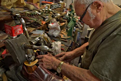 In this Jan. 29, 2020 file photo, Tony Bonczewski repairs a heel on a customer's shoe at his cobbler shop in Wilkes-Barre, PA. Small business owners have received some upbeat news on the economy this month. Retail sales figures released Friday showed that consumers were inspired by unseasonably warm weather to spend on their homes in January, but that overall sales growth was modest.