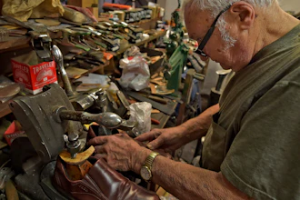 In this Jan. 29, 2020 file photo, Tony Bonczewski repairs a heel on a customer's shoe at his cobbler shop in Wilkes-Barre, PA. Small business owners have received some upbeat news on the economy this month. Retail sales figures released Friday showed that consumers were inspired by unseasonably warm weather to spend on their homes in January, but that overall sales growth was modest.