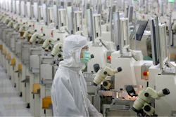 In this Feb. 20 photo, a worker sits at a production line at a microelectronics factory in Nantong in eastern China's Jiangsu Province. China on Friday suspended more punitive tariffs on imports of U.S. industrial goods in response to a truce in its trade war with Washington that threatened global economic growth.