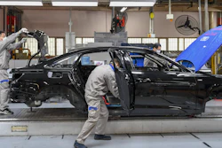 In this Feb. 17 file photo released by Xinhua News Agency, workers assemble Audi A6 L cars at a workshop of FAW-Volkswagen Automobile Co., Ltd. in Changchun, northeast China's Jilin Province.