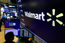 In this Feb. 18, 2020 file photo, the logo for Walmart appears above a trading post on the floor of the New York Stock Exchange. Walmart is confirming that it's developing a competitor to Amazon's juggernaut Prime membership program. The company declined on Thursday, Feb. 27 to offer details, but a spokeswoman said it will be called Walmart+.