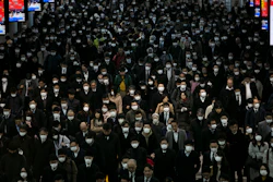 A large crowd wearing masks commutes through Shinagawa Station in Tokyo on Tuesday, March 3. The Japanese government has indicated it sees the next couple of weeks as crucial to containing the spread of COVID-19, which began in China late last year.
