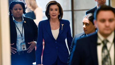 House Speaker Nancy Pelosi of Calif., arrives on Capitol Hill in Washington on Friday, March 27.