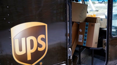 In this Dec. 19, 2018, file photo packages await delivery inside of a UPS truck in Baltimore. United Parcel Service Inc. reports financial results on Thursday, Jan. 30, 2020.
